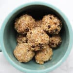 Oatmeal "cookie" energy balls with chocolate chips in a large blue mug.