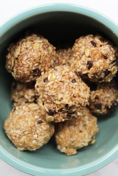 Oatmeal "cookie" energy balls with chocolate chips in a large blue mug.