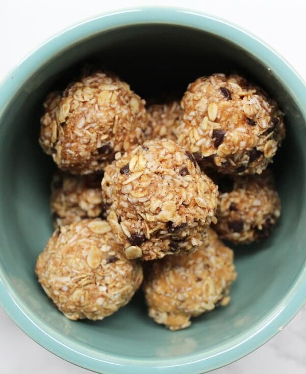 Oatmeal "cookie" energy balls with chocolate chips in a large blue mug.