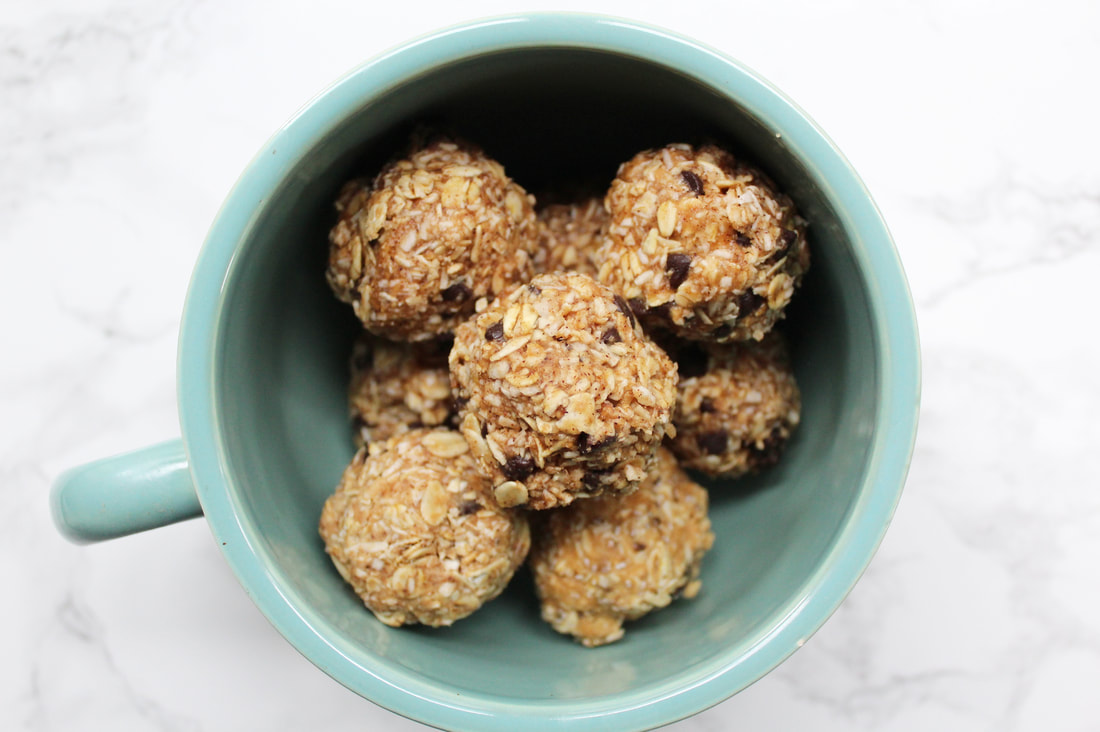 Oatmeal "cookie" energy balls with chocolate chips in a large blue mug.