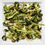 Lemon Broccoli with almonds and parmesan on white plate