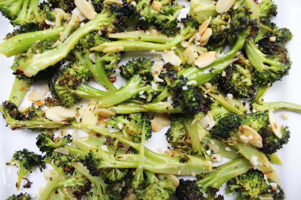 Close-up of Lemon Broccoli with almonds and parmesan on white plate