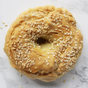 Gluten-Free Sesame Bagels on white marble backdrop.