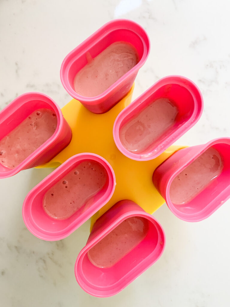 Pink smoothie in popsicle mold.