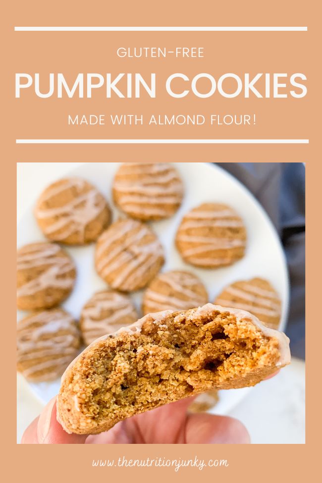 Pinterest Pin with title: "gluten-free pumpkin cookies made with almond flour!". Photo of cookies on a plate and one cookie being held to camera with a bite taken out of it. Orange background.