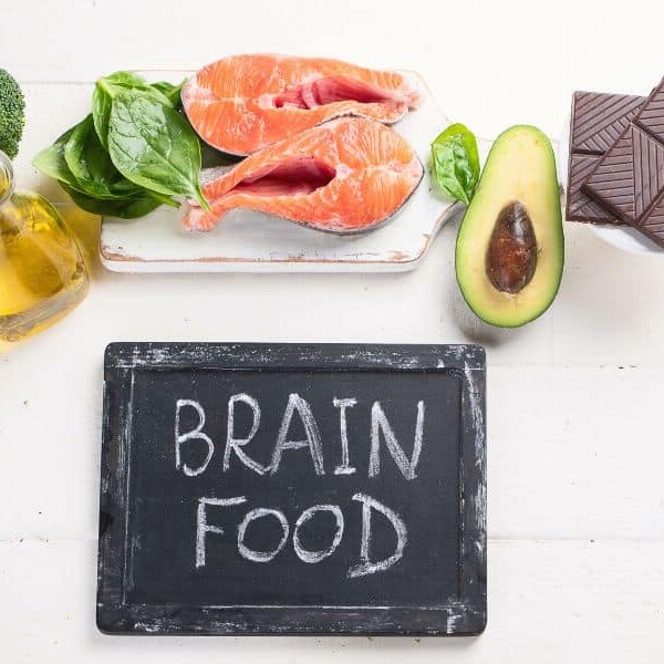 Chalk board that says "brain food" with healthy foods for an ADHD diet overtop.