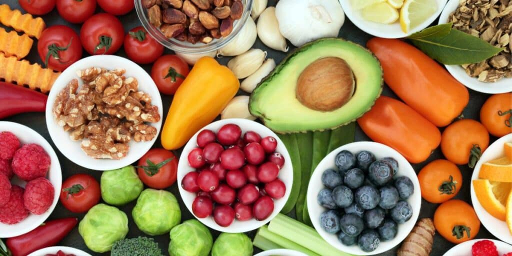 Bird's eye view of healthy foods like fruit, vegetables and nuts.