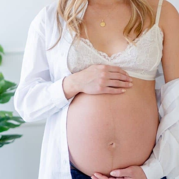 Pregnant woman holding belly.