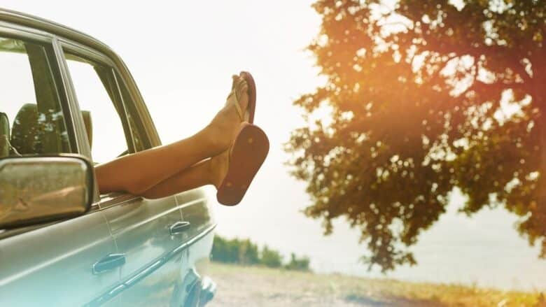 Car with feet coming out the window.
