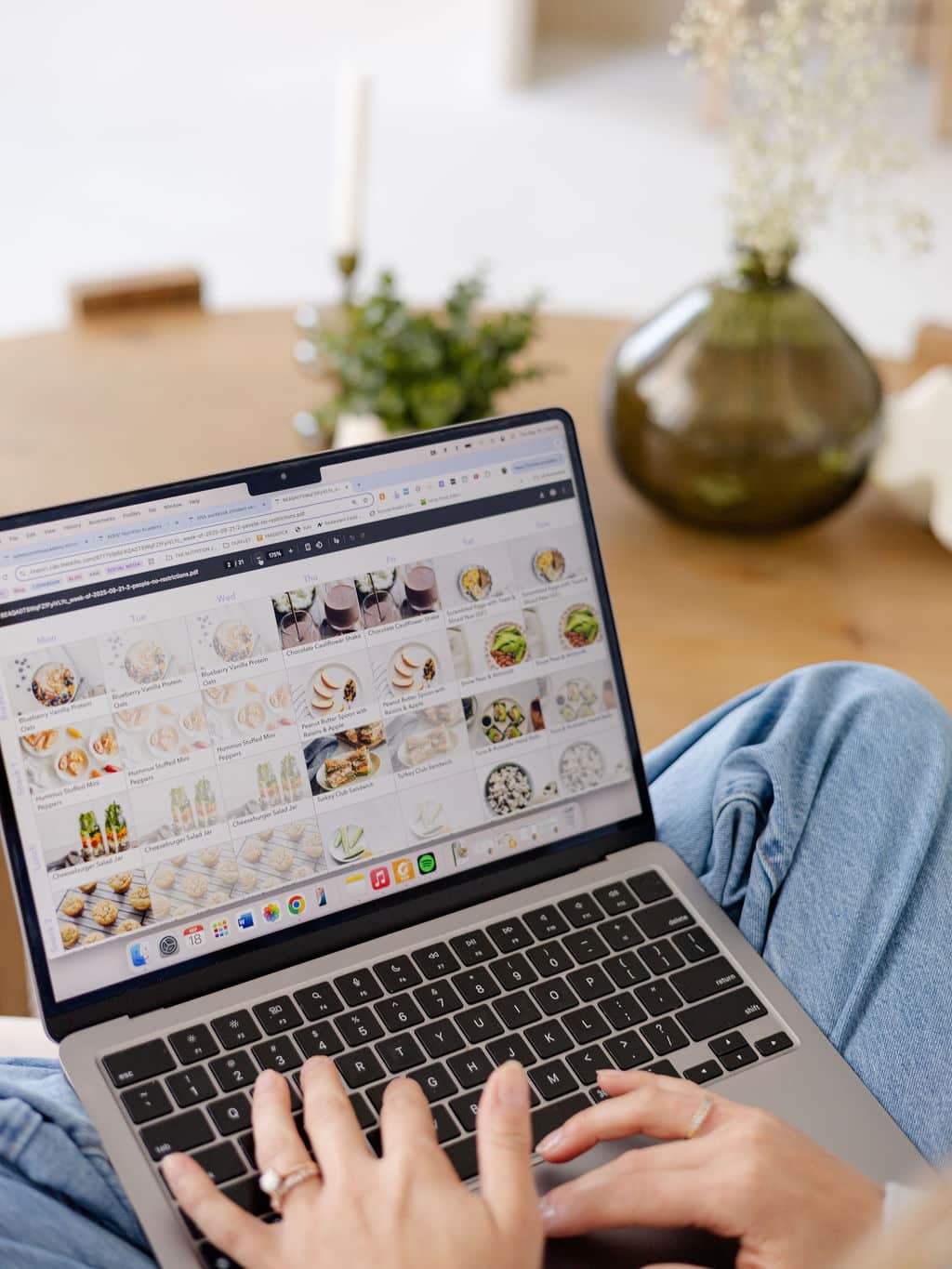 Computer screen with meal plans and someone typing on the keyboard.