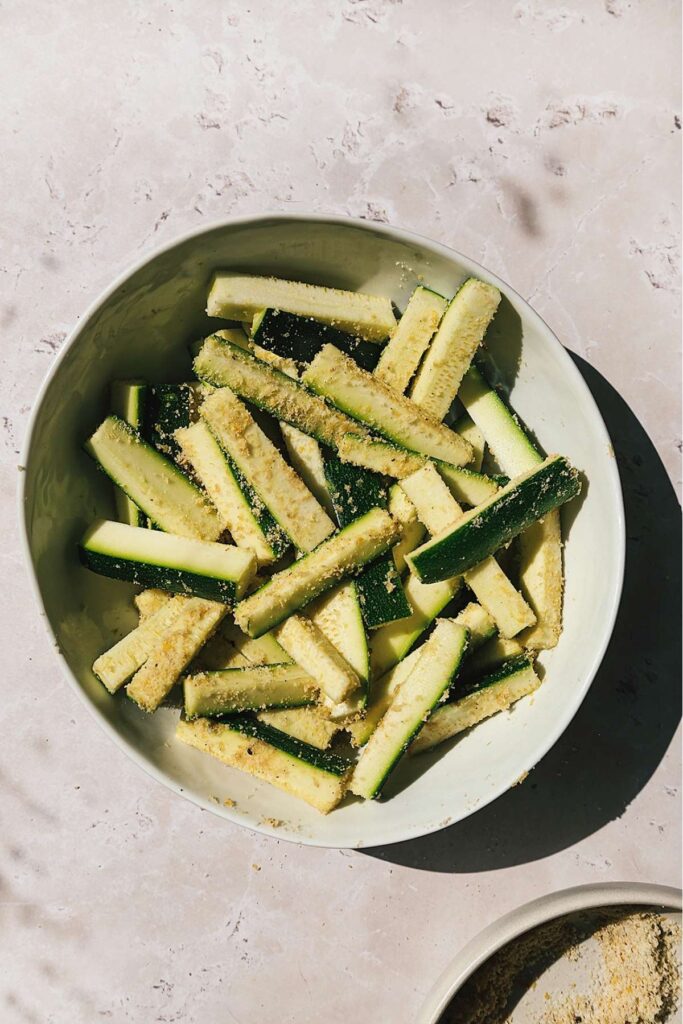 Overhead shot of uncooked zucchini in a bowl