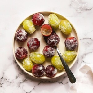 Overhead shot of green and red grapes on a plate.