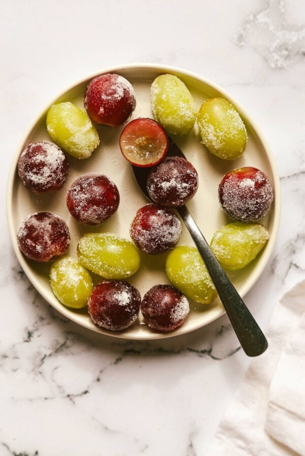 Close-up overhead shot of green and red grapes on a plate.